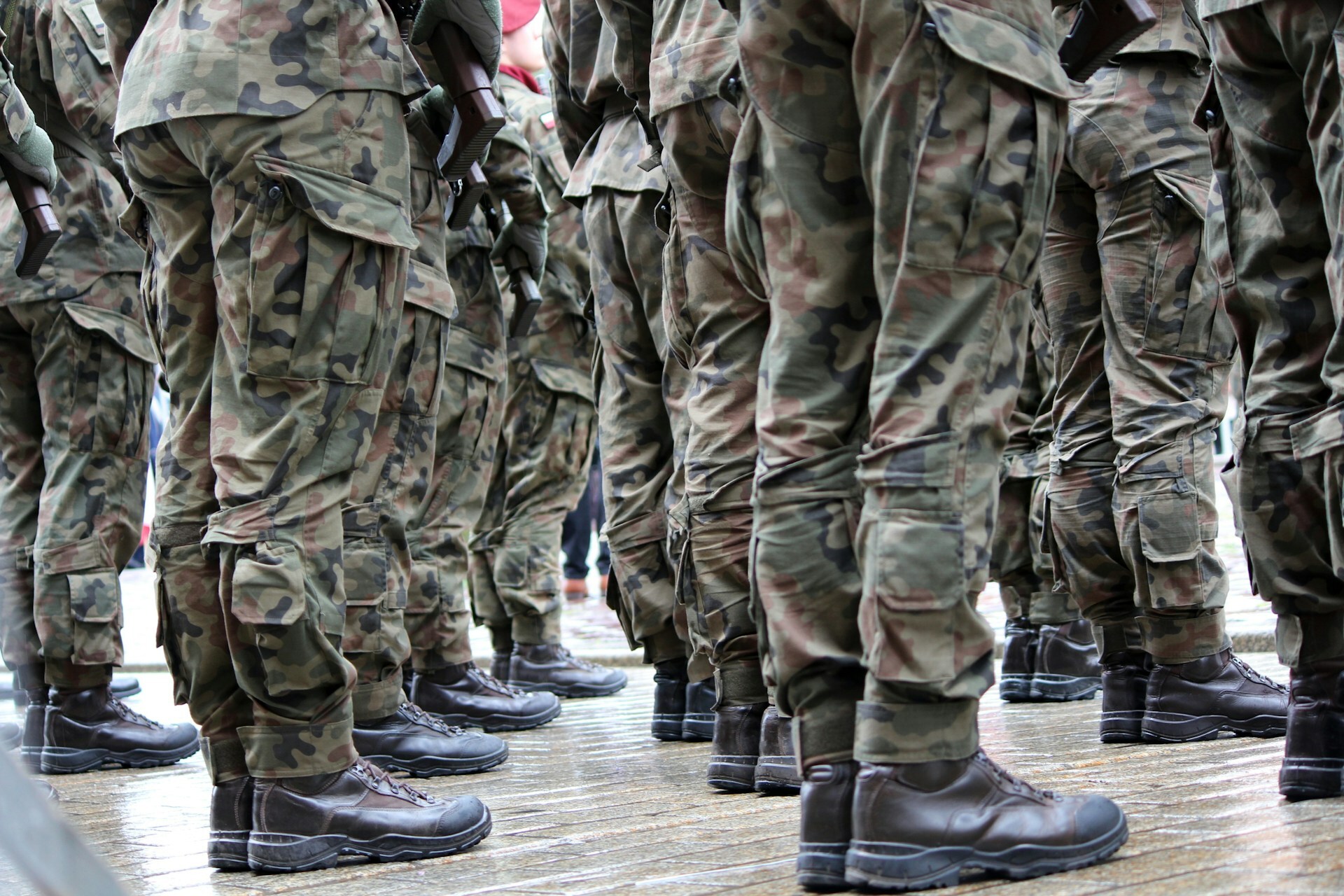 military members in camo uniforms and boots