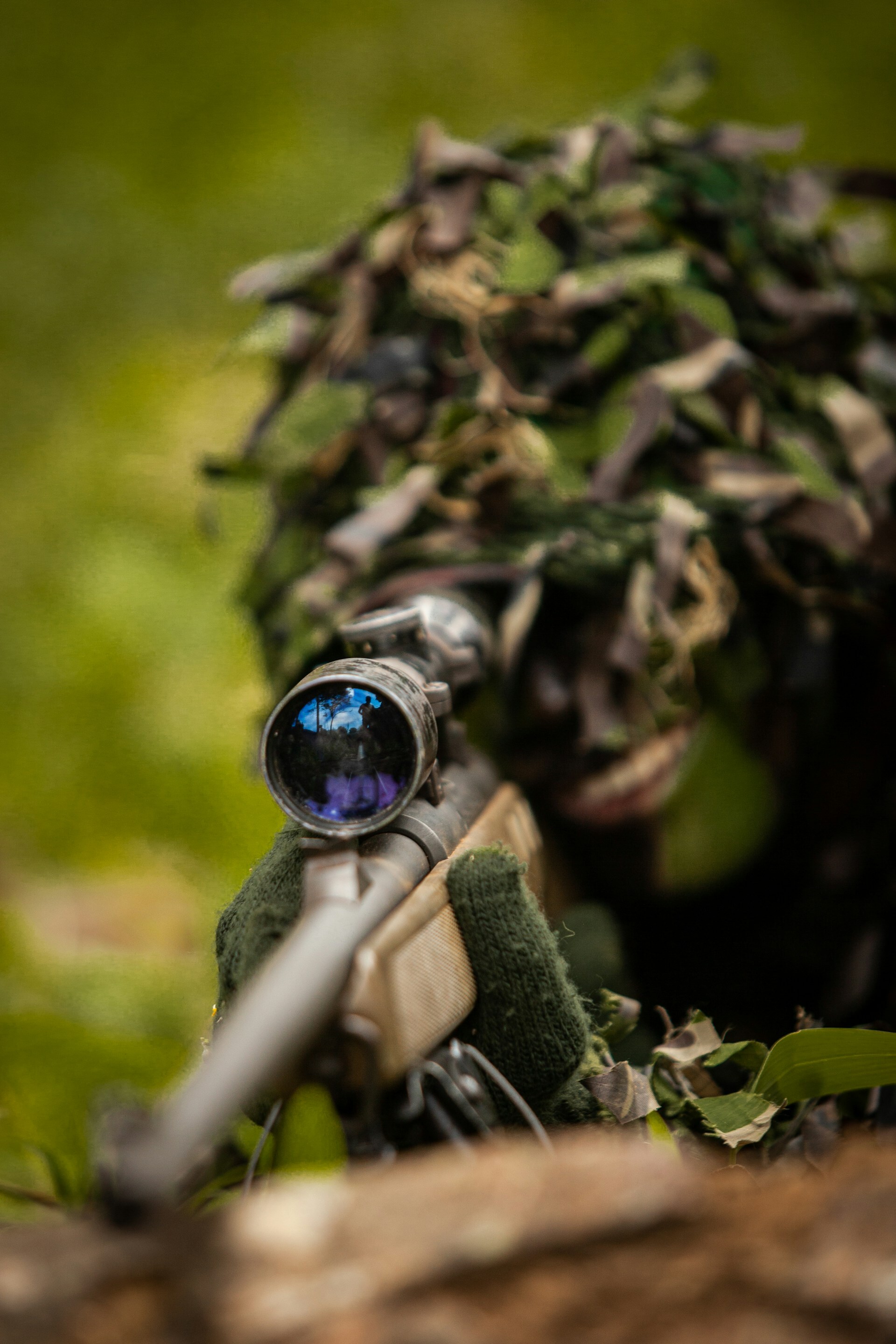 person in camouflage aiming toy gun